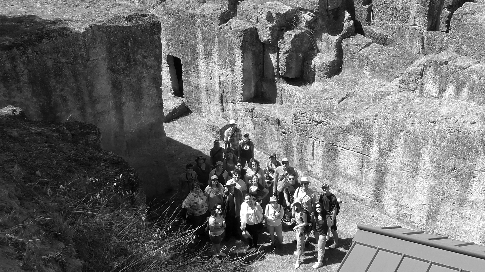 Black and white photograph of 2012 Classical Summer School participants at the Tomba degli Aninas at Tarquinia