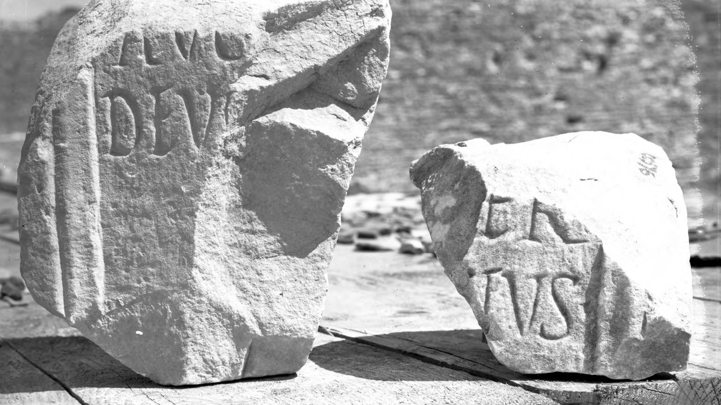 Black and white photograph of two stone fragments with inscriptions