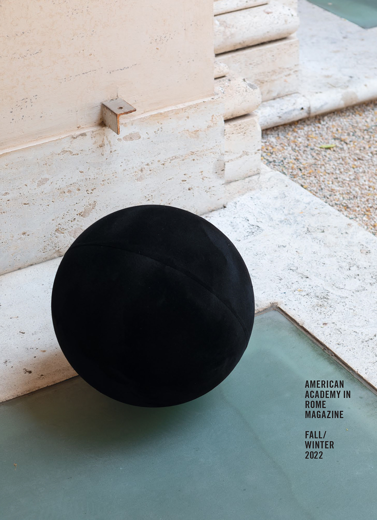 Cover of the Fall–Winter 2022 AAR Magazine  Magazine cover with a color photograph that depicts a sculpture by William Villalongo consisting of a black ball placed on a frosted green basement skylight next to an architectural pillar in the Academy's courtyard
