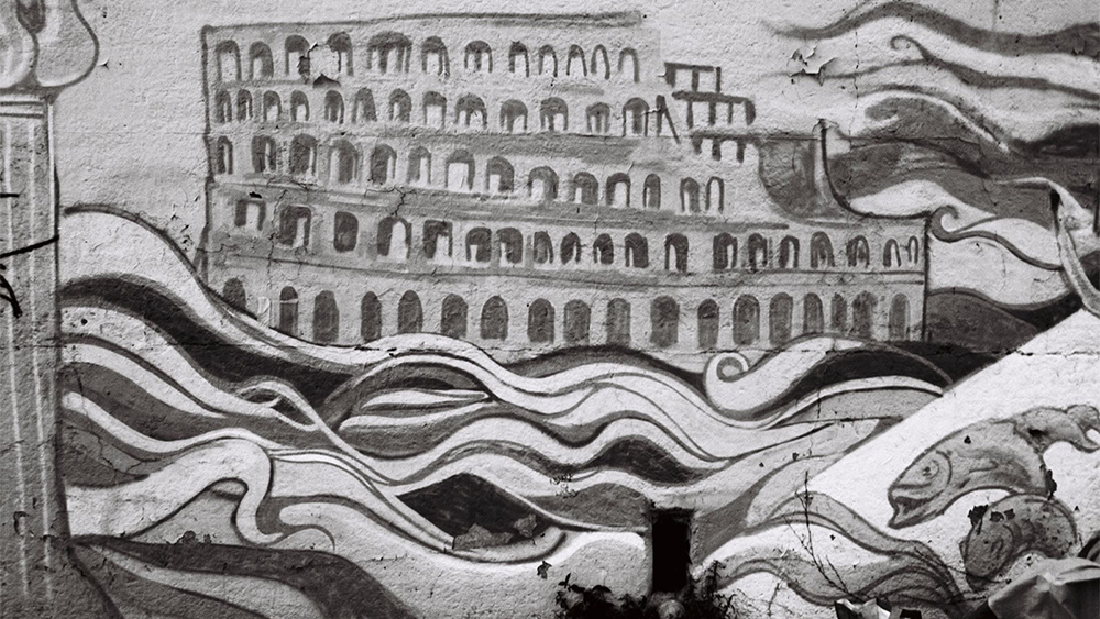 Black and white photo of a painted mural depicting the Roman Colloseum