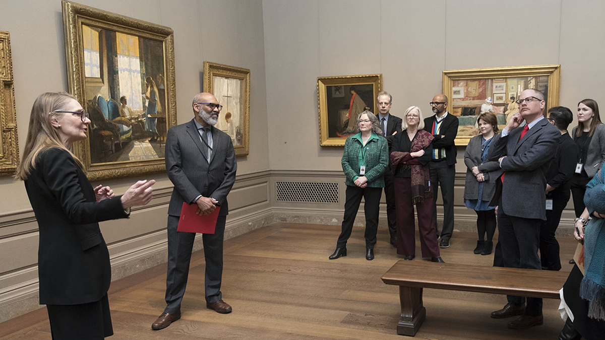Color photograph of Richard Powell leading a tour group in the galleries of the National Gallery of Art