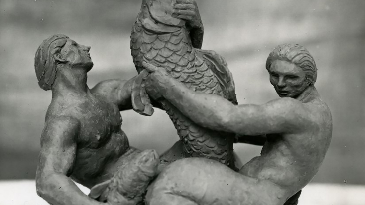 Black and white photograph of a Harrison Gibbs sculpture consisting of two male figures wrestling with a large fish