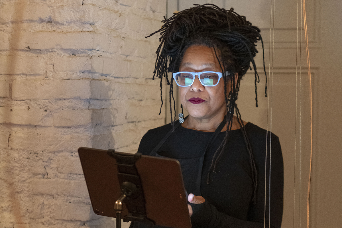 Color photograph of Pamela Z performing her musical composition with an iPad at AAR during the 2020 Cinque Mostre exhibition