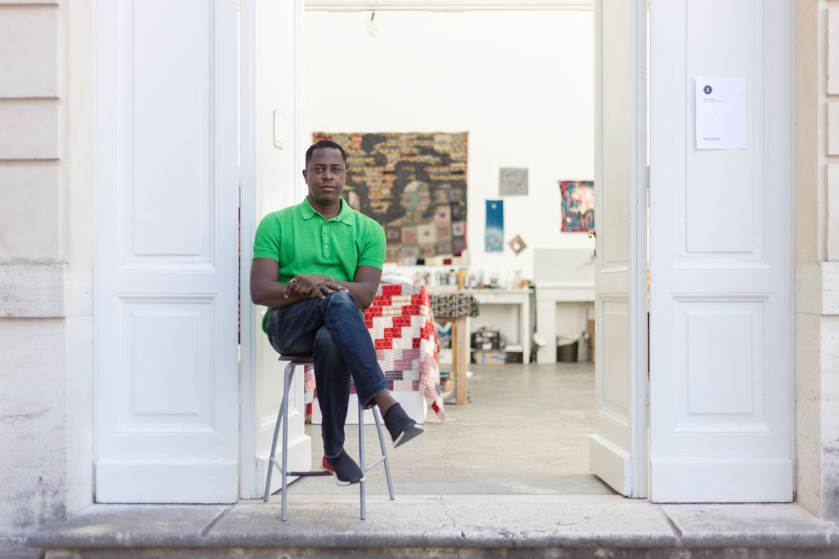Sanford Biggers (2018 Fellow) sitting in front of his AAR studio during Open Studios