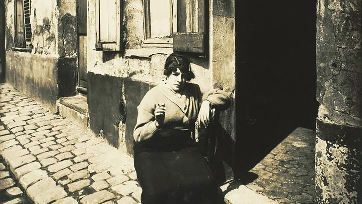 Detail of a monchromatic photo of a woman on the street in the early 20th century