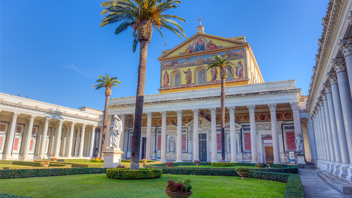 Color photo of the exterior of a neoclassical nineteenth century basilica in Rome on a sunny day